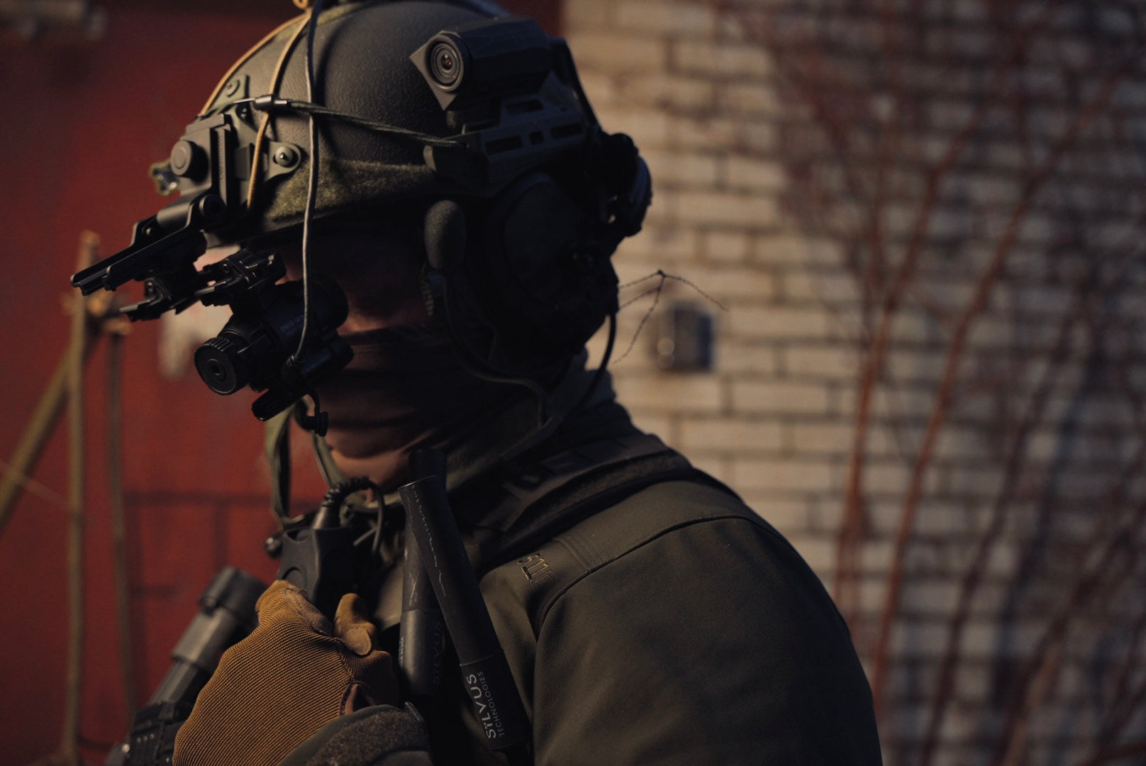 Profile of a tactical operator wearing the DNVS-14 Pro on a helmet mount, featuring a Silvus antenna.