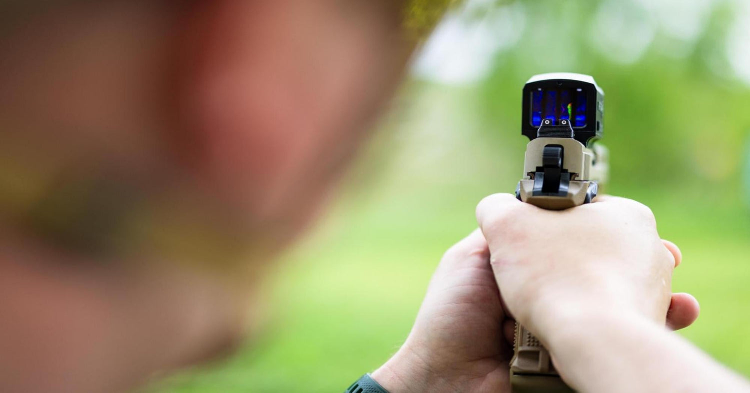 A security guard using a thermal imaging scope