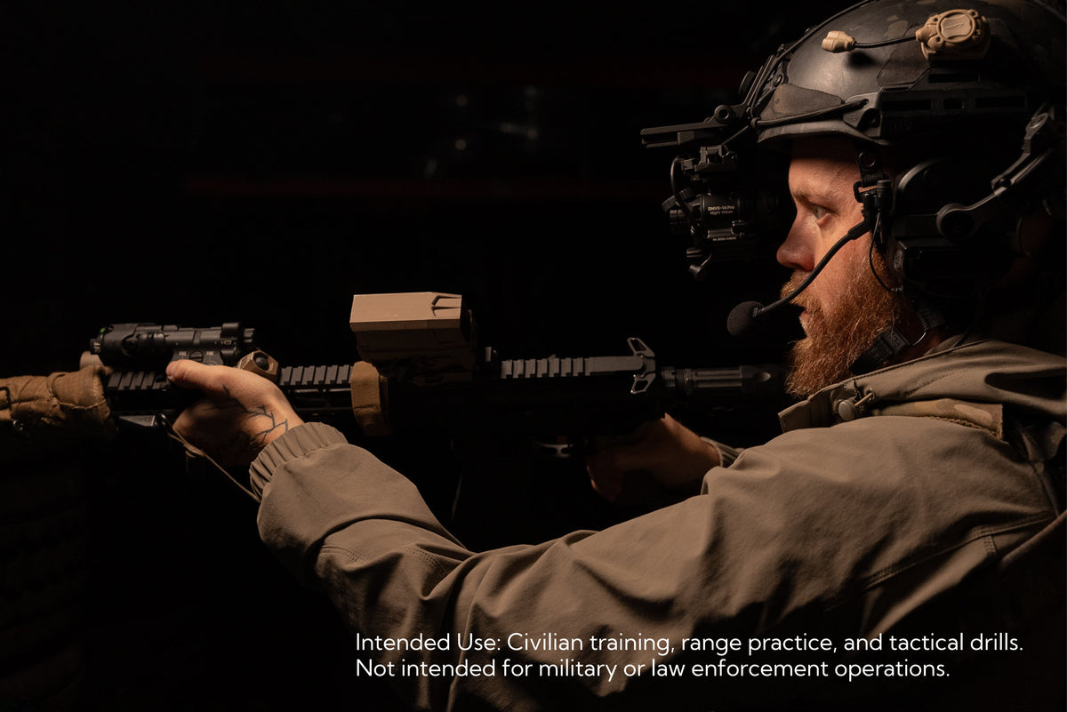 Close-up of a bearded man aiming a rifle while equipped with the INFITAC Night Vision Goggles DNVS-14 Pro in low light