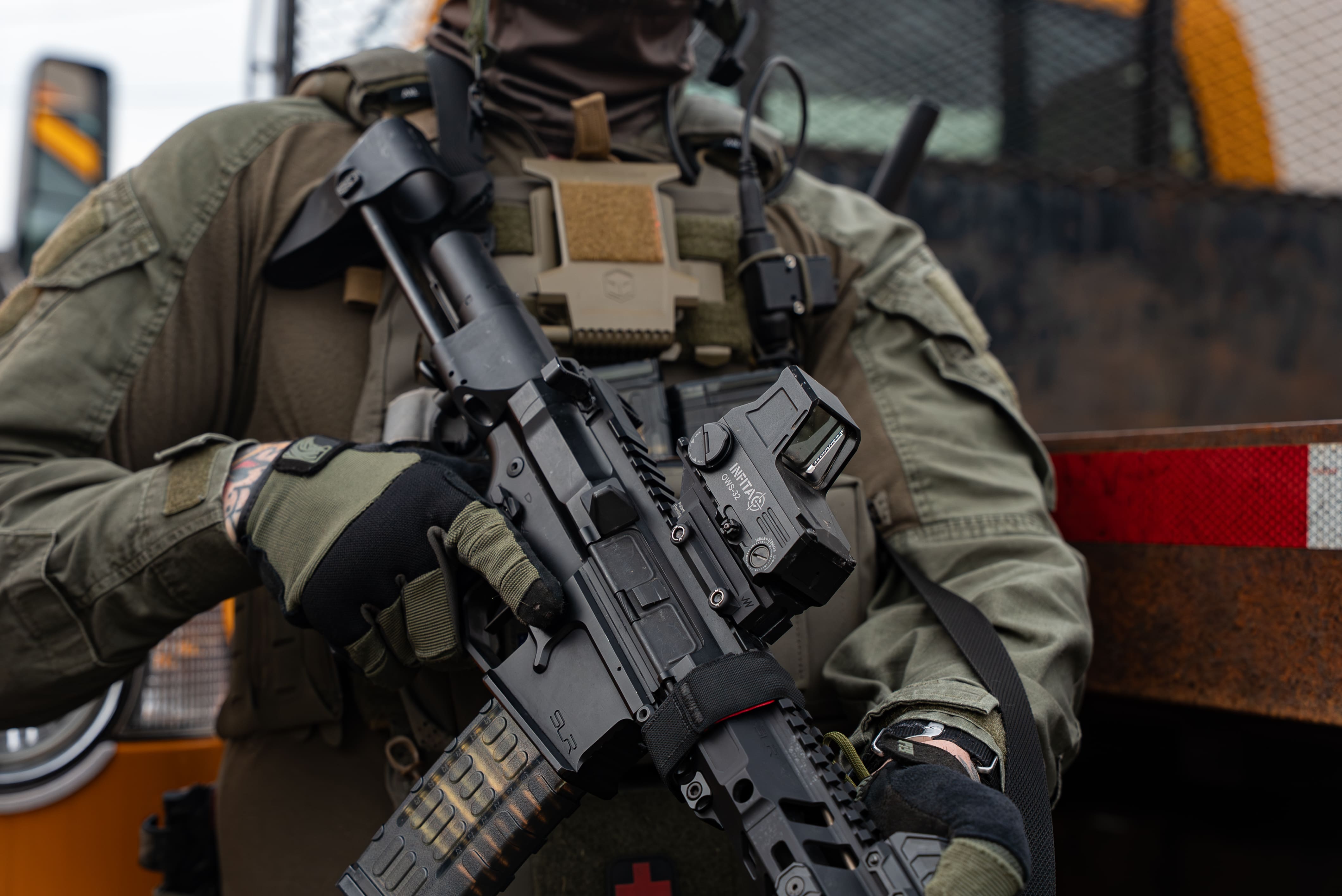 Tactical professional holding a rifle fitted with the Infitac OWS-32 OPTICAL WAVEGUIDE SIGHT