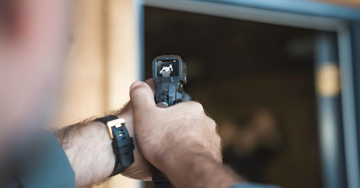 A person is using a gun with a inficusa scope