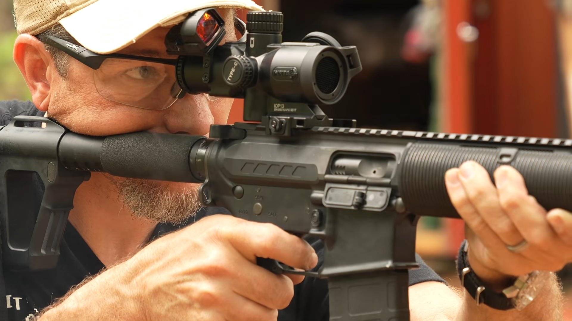 Man aiming rifle with IOTS IOP13 thermal scope attached