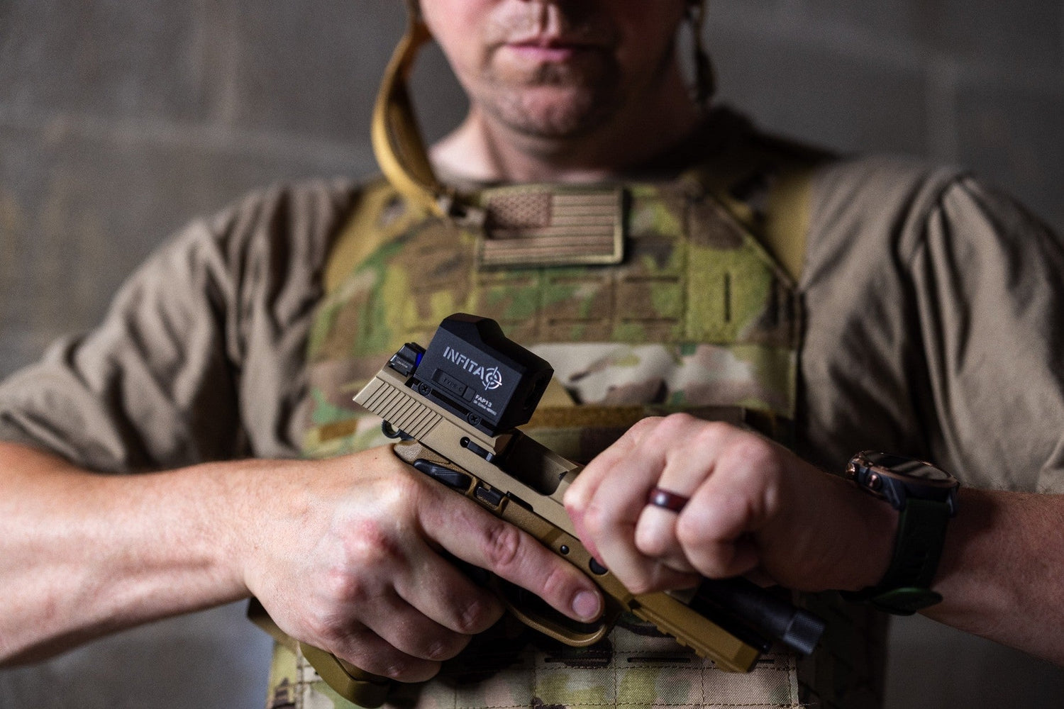 Handgun with red dot sight and tactical light, next to night vision goggles