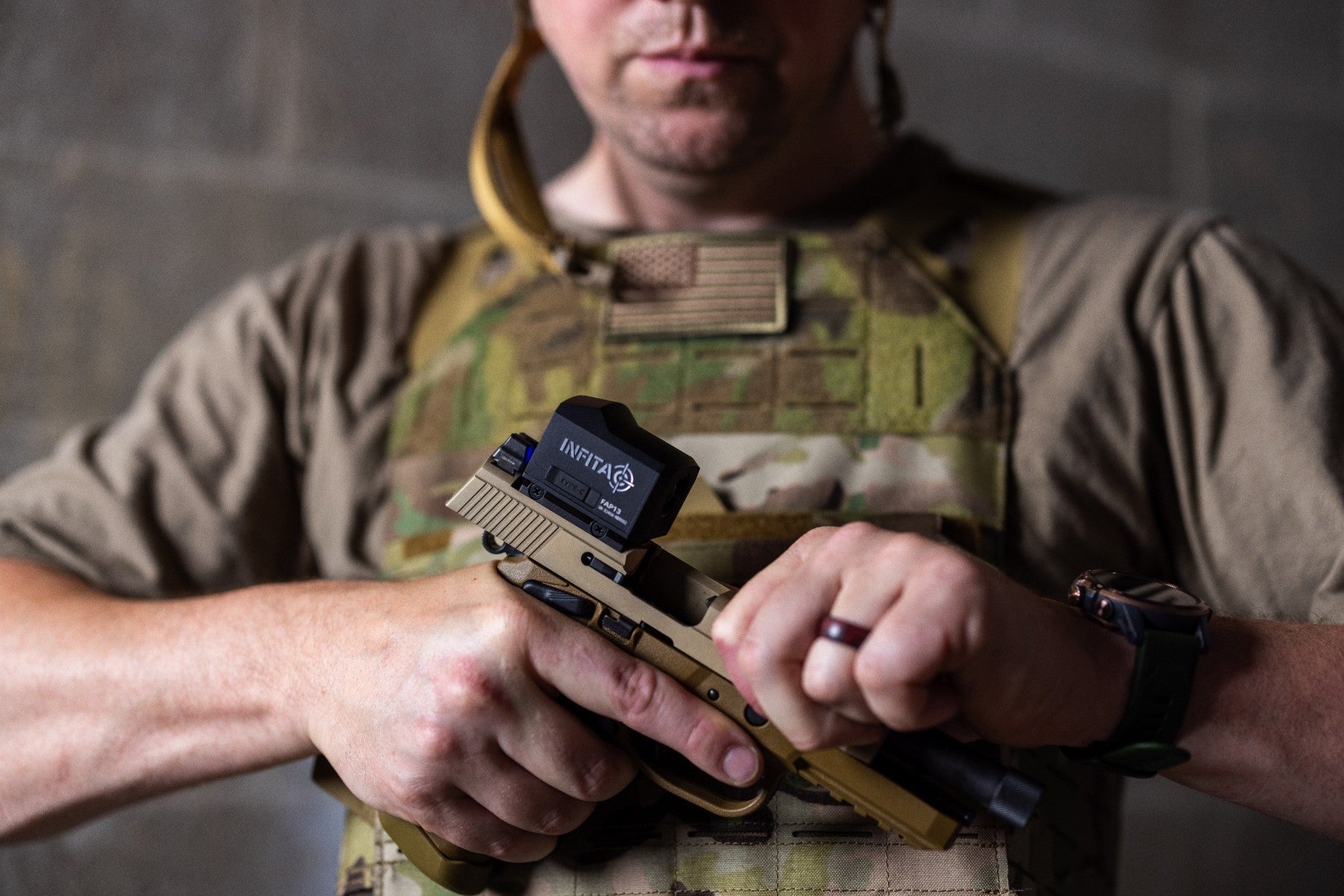 Handgun with red dot sight and tactical light, next to night vision goggles
